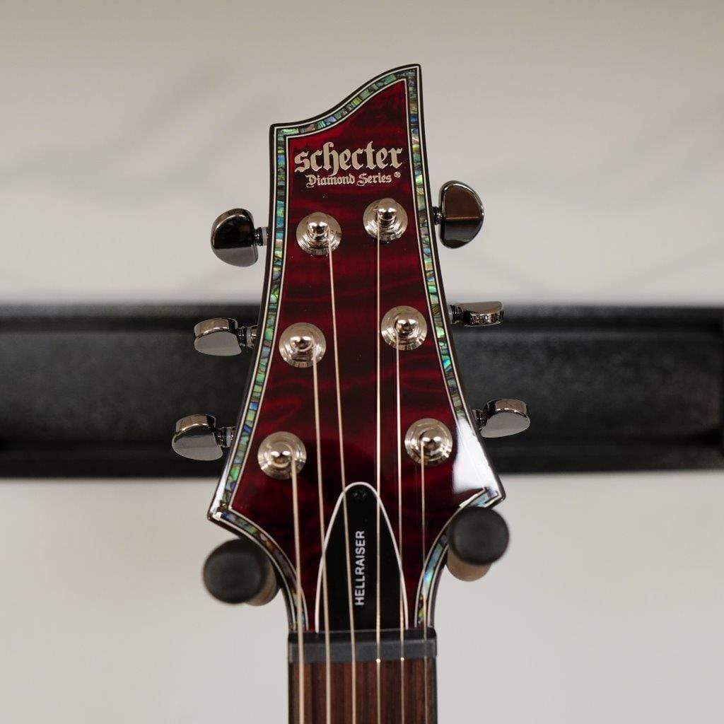 Schecter Hellraiser C-1 Black Cherry Electric Guitar close-up showing strings, tuning pegs, and headstock details.