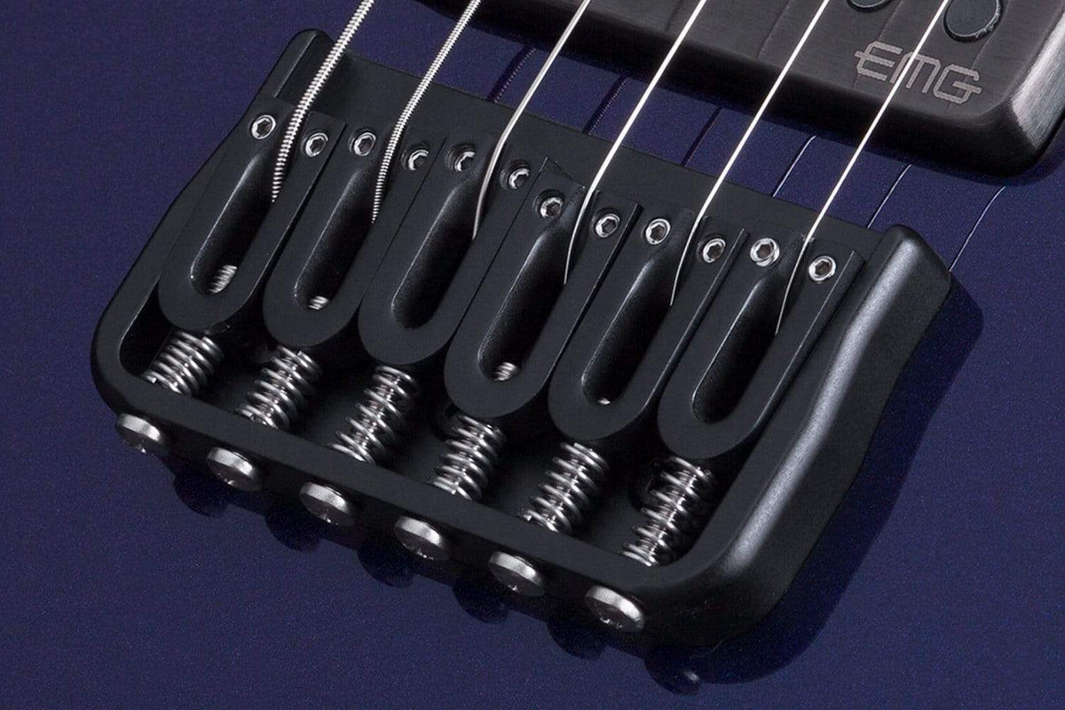 Schecter Hellraiser Hybrid PT Ultra Violet close-up, showcasing strings, pickups, and bridge for hard rockers seeking versatile tones and comfortable playability.