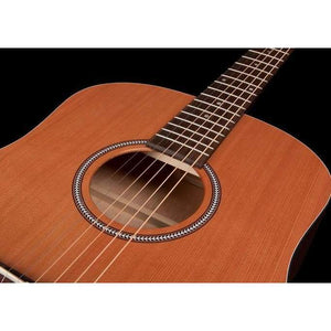 Close-up of a Seagull S6 Original Left Handed Acoustic Guitar (Blemished) by Seagull, featuring part of the cedar top, sound hole with decorative rosette, and lower neck and fretboard against a black background.