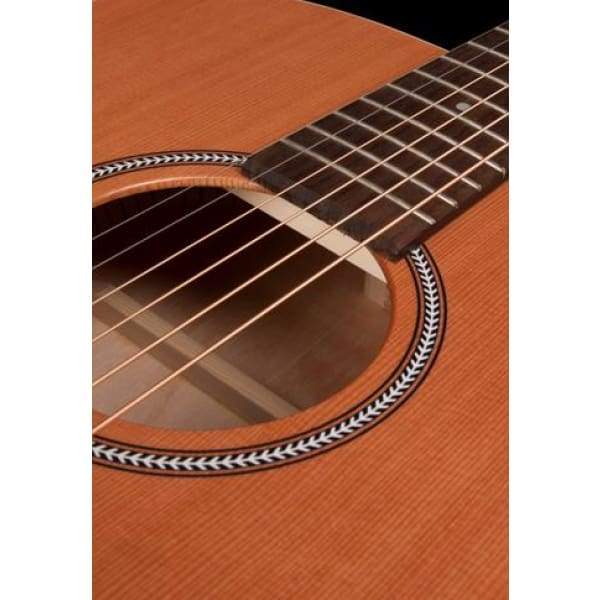 Close-up of the Seagull S6 Original Left Handed Acoustic Guitar (Blemished) by Seagull, highlighting the sound hole with a decorated rosette, strings, fretboard, and its natural cedar top finish.