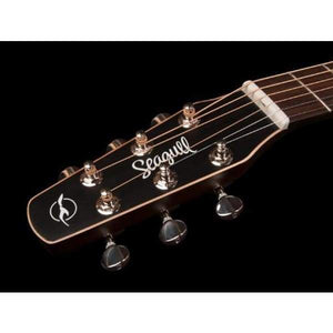 Close-up of the Seagull S6 Original Left Handed Acoustic Guitar (Blemished) headstock against black, featuring six tuning pegs, string posts, and the Seagull logo in white—a signature detail of this cedar-top model.