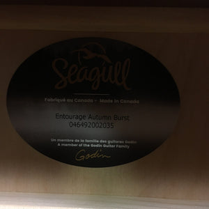 A close-up photo shows the Seagull Entourage Autumn Burst Acoustic Guitar label inside the body, featuring its model name and serial number, and stating it's made in Canada by Seagull.