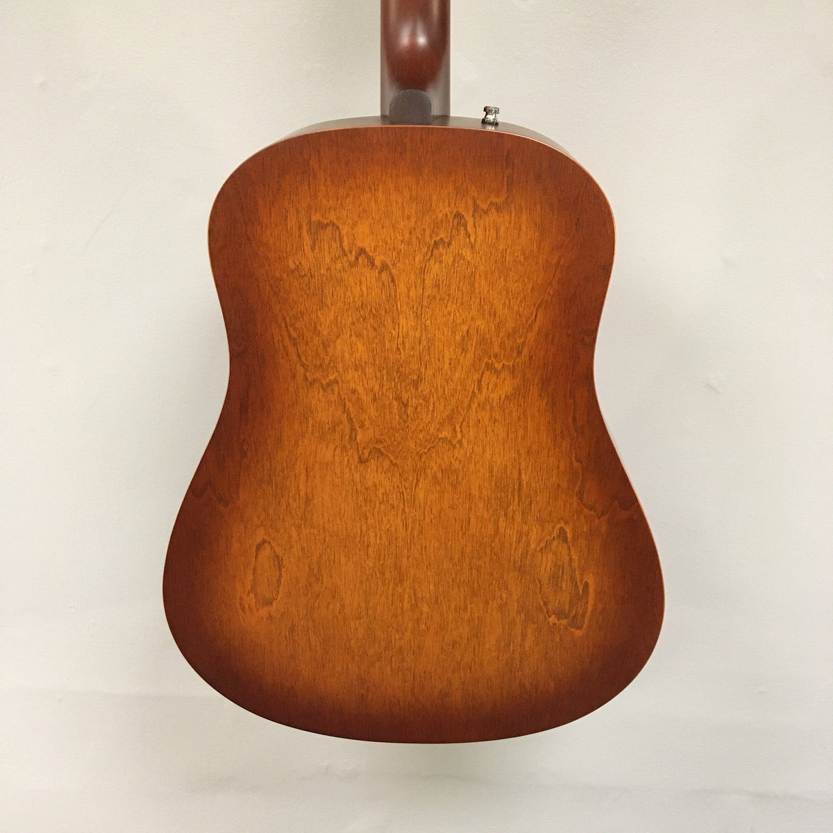 The back of the Seagull Entourage Autumn Burst Acoustic Guitar showcases a warm brown finish, visible wood grain, and a smooth, slightly glossy surface set against a plain white background.