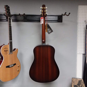 Seagull Maritime SWS Mahogany Burnt Umber GT QIT Acoustic Guitar displayed on a wall, highlighting its craftsmanship and vintage elegance.