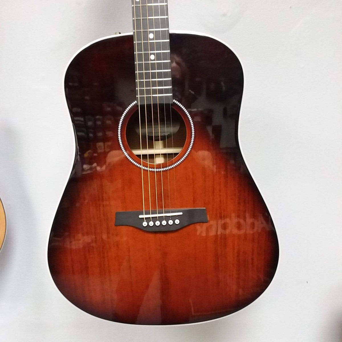 Seagull Maritime SWS Mahogany Burnt Umber GT QIT Acoustic Guitar displayed in a case, showcasing its solid wood construction and elegant finish.