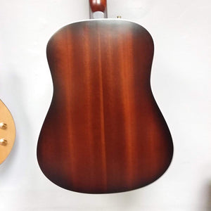 Seagull Maritime SWS Mahogany Burnt Umber GT QIT Acoustic Guitar hanging on a wall, showcasing its elegant design and craftsmanship.