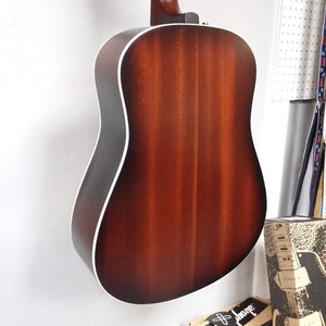 Seagull Maritime SWS Mahogany Burnt Umber GT QIT Acoustic Guitar hanging on a wall, showcasing its elegant design and craftsmanship.