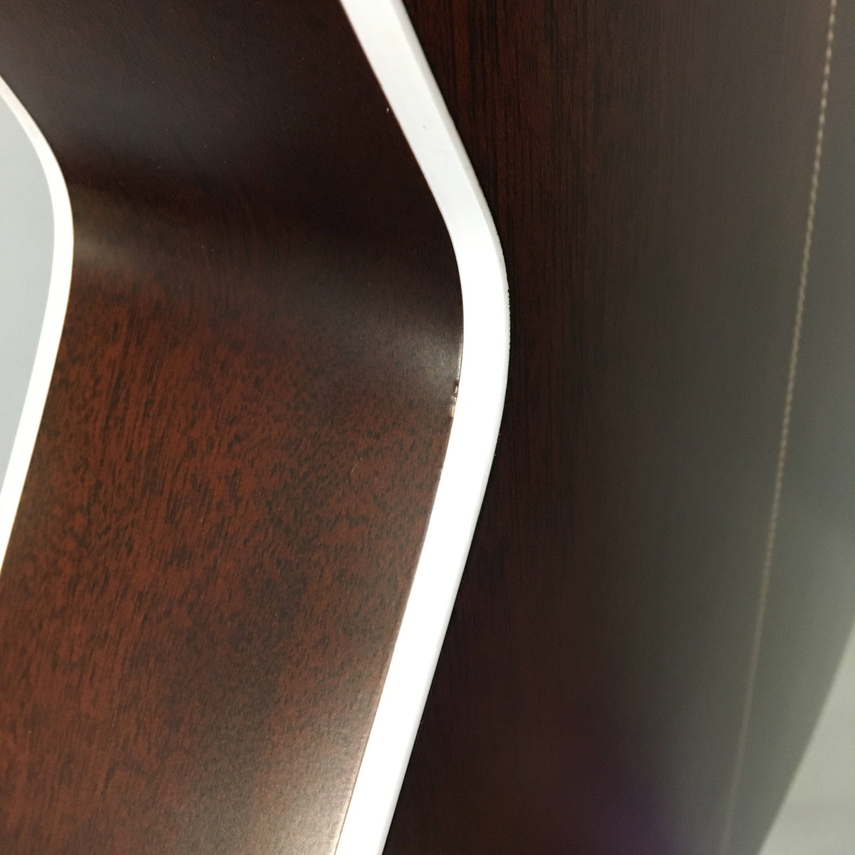 Seagull Artist Mosaic CH CW GT EQ Bourbon Burst guitar, showcasing close-up details of its wood surface and binding.