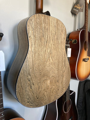 Seagull S6 Classic A/E Black acoustic guitar with a semi-gloss finish, hanging on a wall.