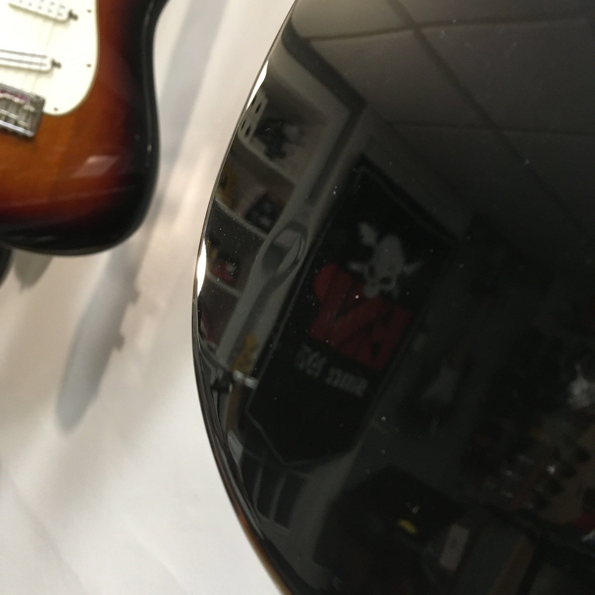 Squier Classic Vibe '70s Stratocaster Black Refurb, close-up of body and strings, showcasing finish flaw and vintage-style tremolo system.