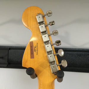Close-up of the Squier Classic Vibe '70s Stratocaster Black Refurb guitar neck, showcasing its vintage-tint gloss finish and nickel-plated hardware.