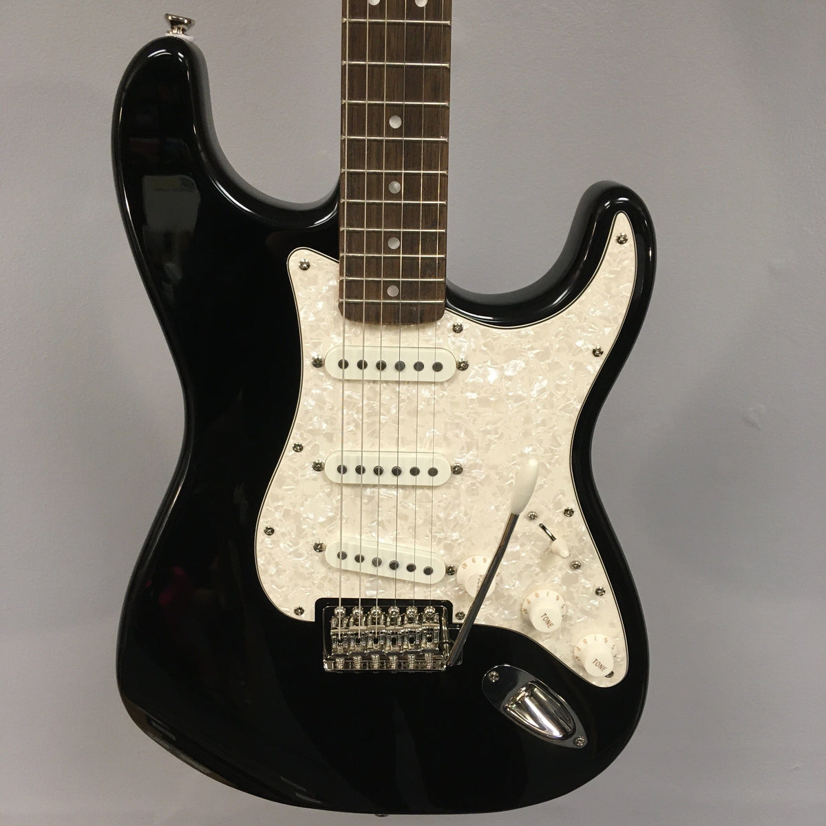 Squier Classic Vibe '70s Stratocaster Black Refurb, highlighting close-up views of its neck, strings, and knobs, showcasing its vintage-style features.