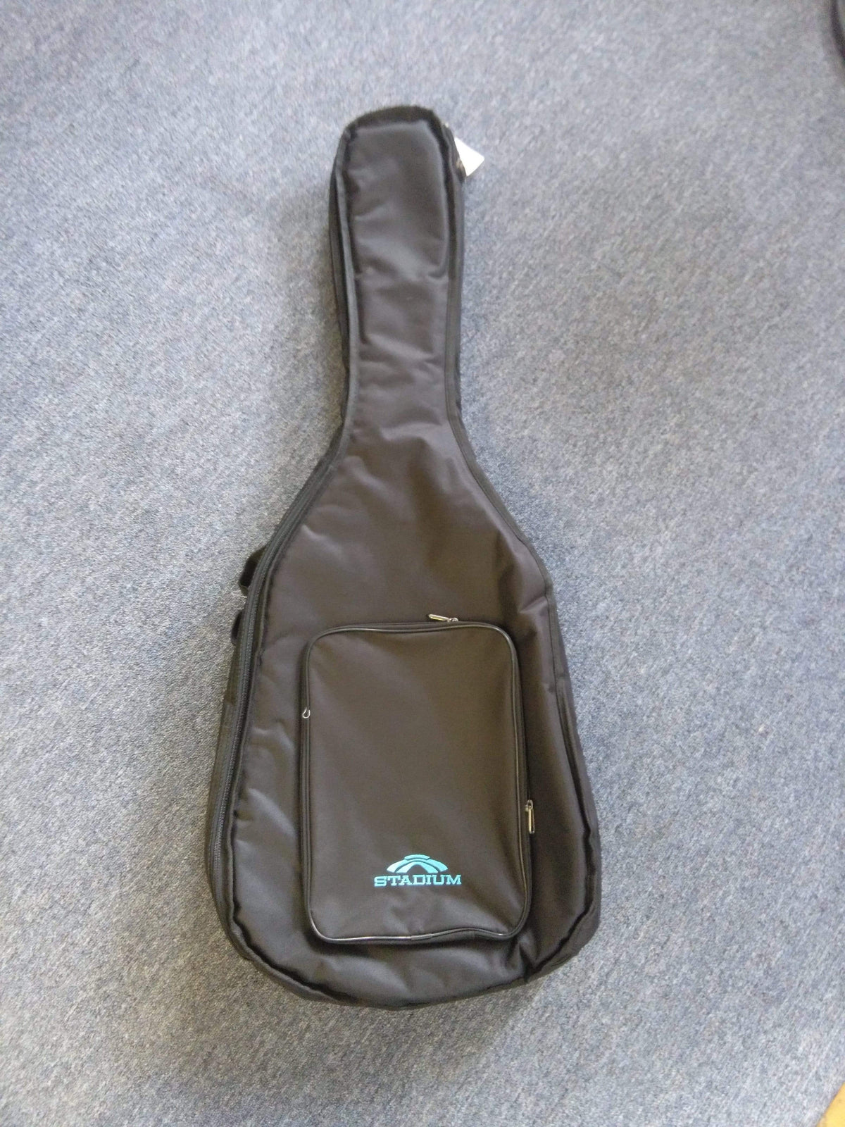 Stadium RD1 Acoustic 1/2 thick Gig Bag on a carpet, designed for dreadnought guitars with reinforced stitching and heavy-duty zippers.
