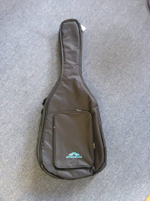 Stadium RD1 Acoustic 1/2 thick Gig Bag on a carpet, designed for dreadnought guitars with reinforced stitching and heavy-duty zippers.