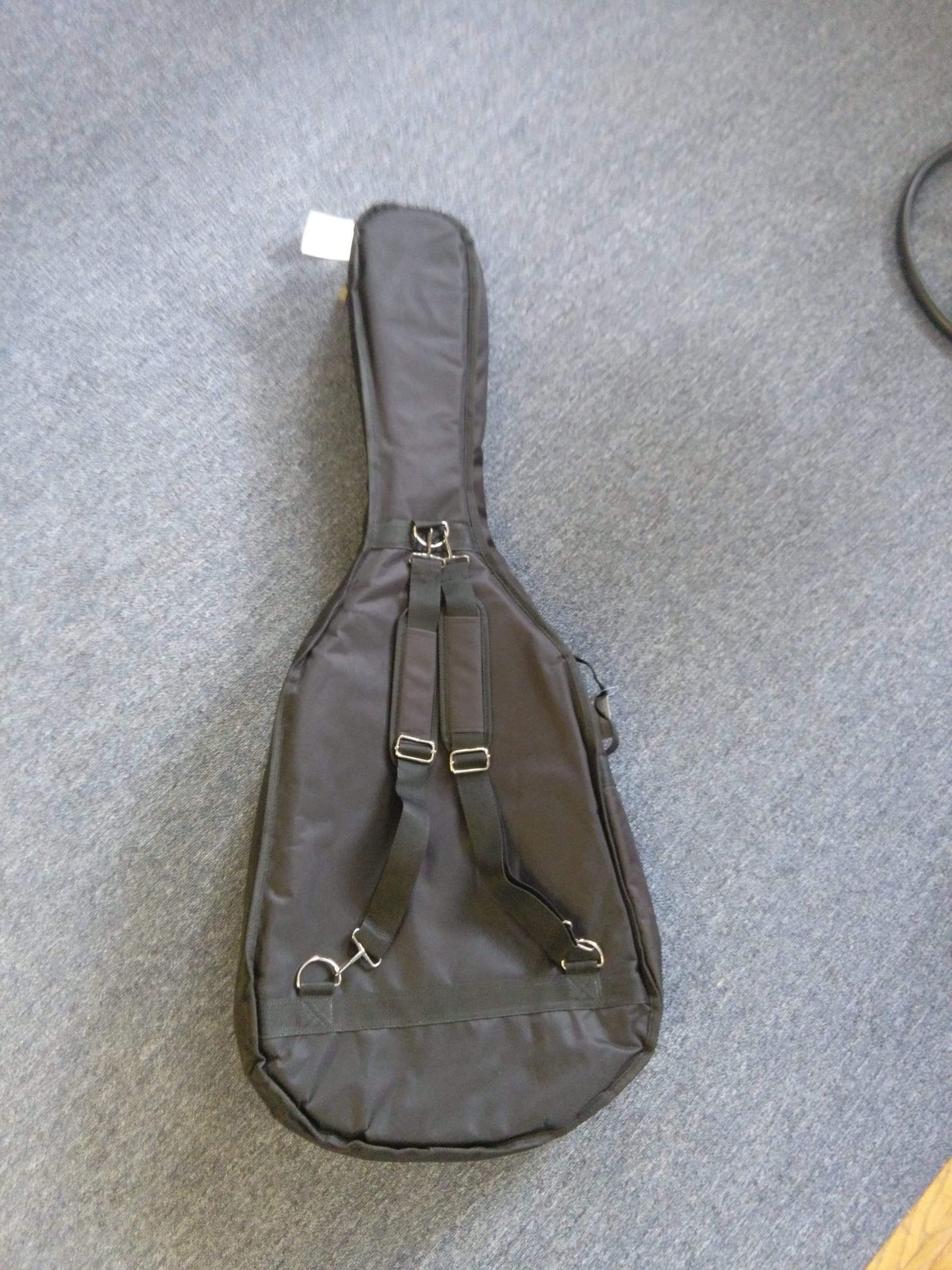 Stadium RD1 Acoustic 1/2 thick Gig Bag for dreadnought guitars, shown on a carpet. Durable, padded case with reinforced stitching and heavy-duty zippers for maximum protection.