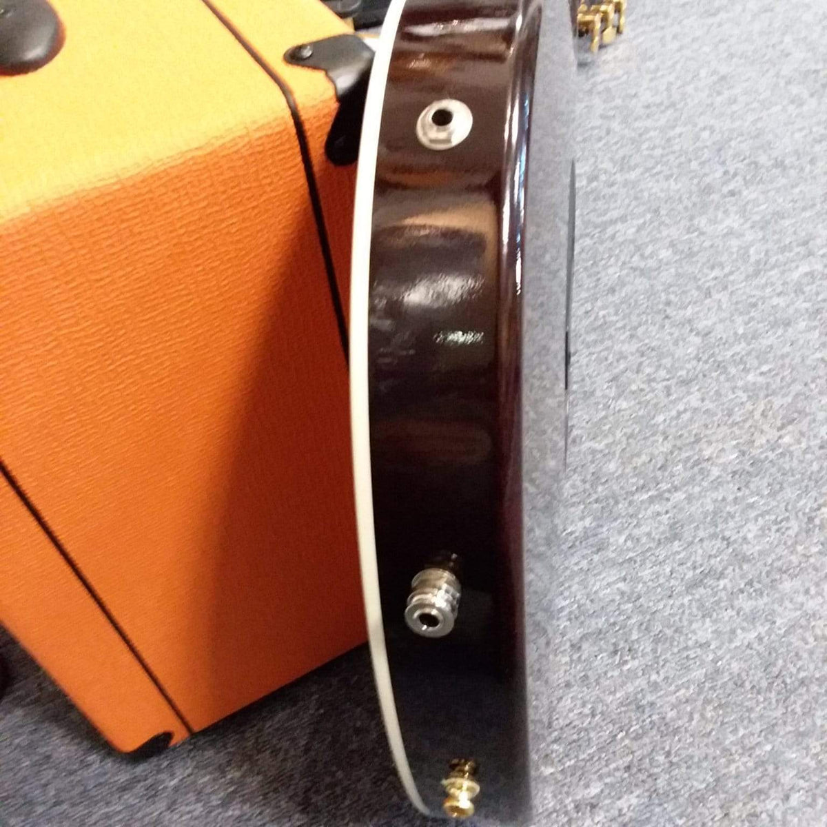 Taylor T5-C 2006 guitar with Custom Fishman Matrix Piezo pickup, shown next to its case, highlighting its versatile acoustic and electric capabilities.