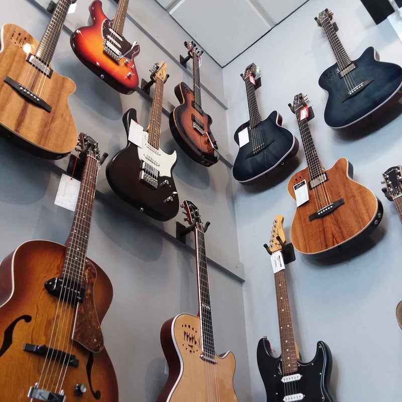 A wall of Godin guitars