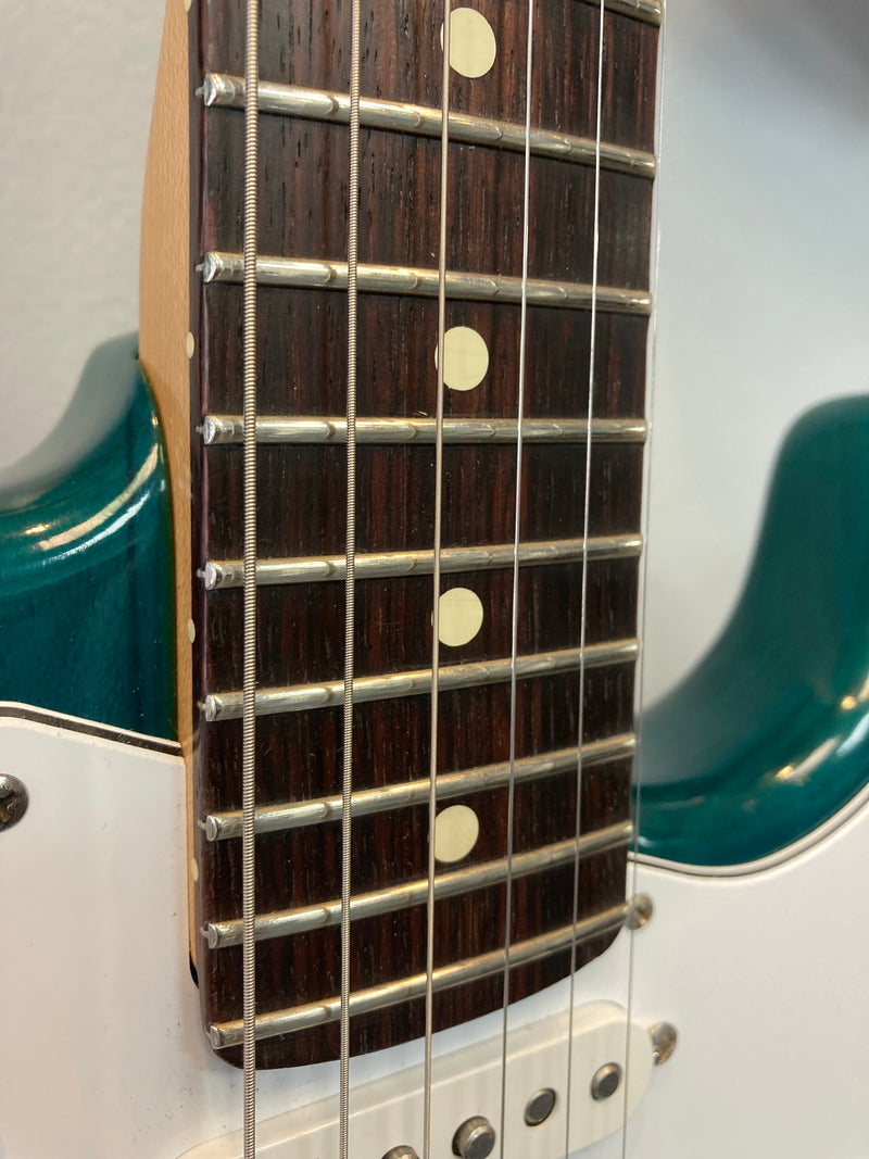 A close-up pic of a guitar fret board where the neck joins the body.
