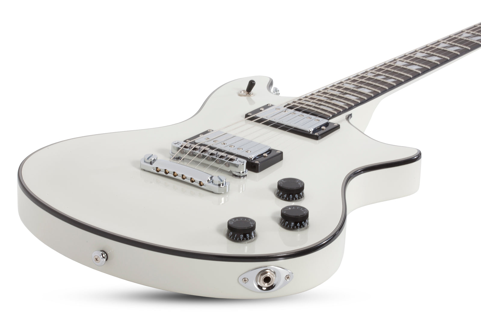 White electric guitar with black knobs, showcasing close-up of strings and dials, representing musical instruments sold at Guitars on Main.