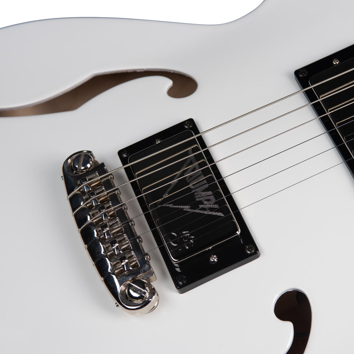 Close-up of a white Godin Rik Emmett Premiere Electric Guitar, highlighting the bridge, strings, pickups, and f-hole on the body—capturing the refined details of this limited edition instrument by Godin.