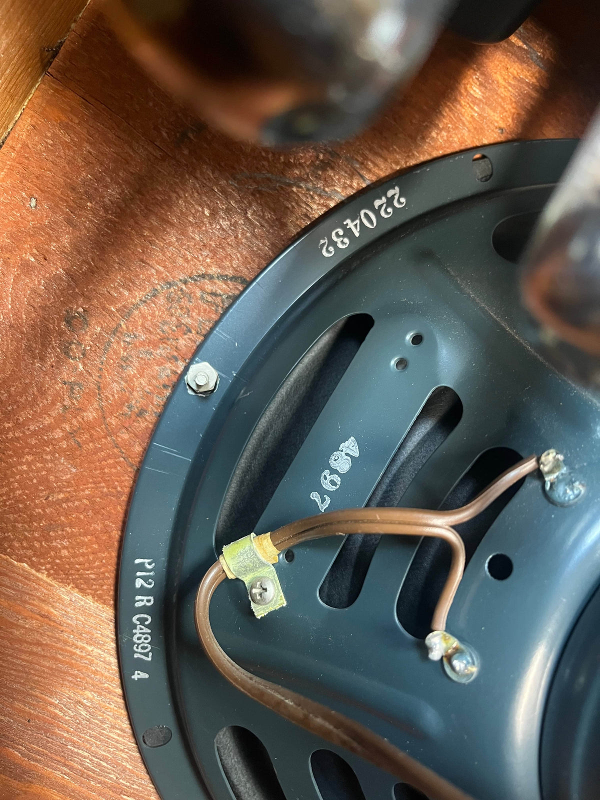 Close-up of the back of a hand-wired 1954 Fender Tweed Deluxe Model 5D3 by Guitars on Main, mounted in a wooden enclosure, showing wiring connections plus stamped serial and model numbers. Includes flight case.