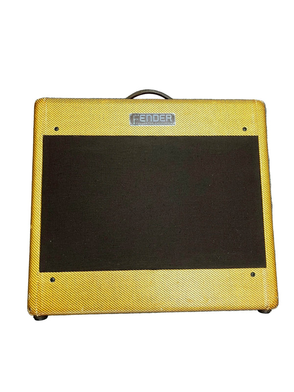 The 1954 Fender Tweed Deluxe Model 5D3 by Guitars on Main features classic tube tone, a yellow cabinet with black grille, top handle, flight case, and is photographed against a white background for timeless vintage style.