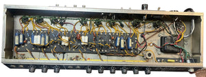 Top-down view of the interior circuitry in a 1965 Fender Deluxe Reverb AB763 Pre-CBS Blackface (Serial A 06439), showing wires, components, and control knobs along the bottom edge.
