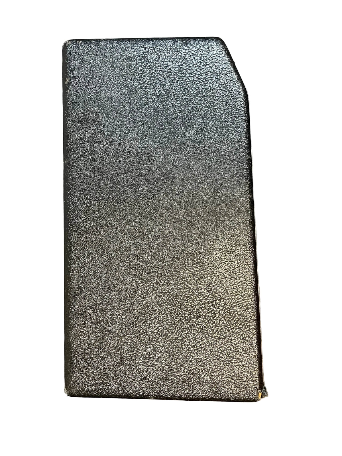 A closed black book with a textured cover and slanted top-right corner, standing upright against a white background, echoes the iconic 1965 Fender Deluxe Reverb AB763 -- Pre-CBS Blackface Serial A 06439 by Fender.
