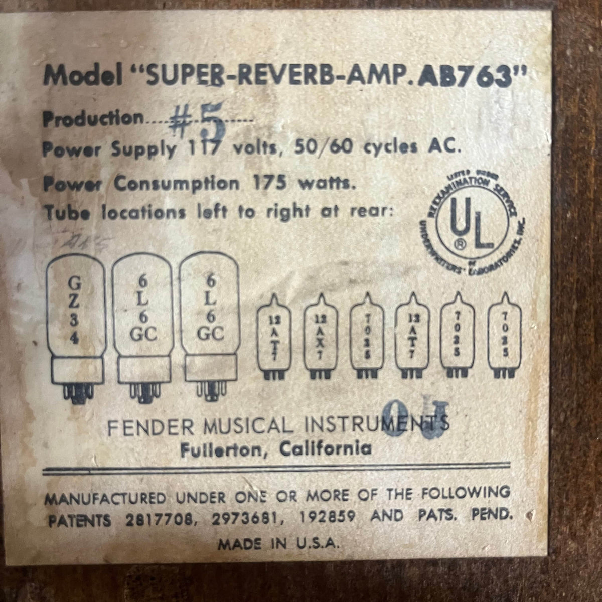 Label on a 1965 Fender Super Reverb - Black Panel - "Player’s Dream" Restoration by Guitars on Main, featuring tube layout, voltage, power usage, certification mark, and Fullerton manufacturing details—evoking classic Blackface sound.