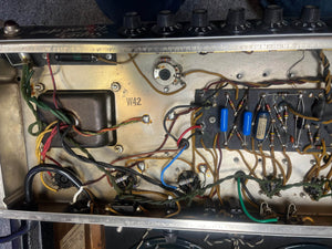 Internal view of the 1965 Fender Super Reverb - Black Panel – "Player’s Dream" Restoration by Guitars on Main, showing wiring and components inside the metal chassis that create its legendary Blackface sound.
