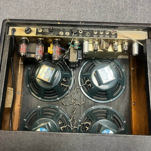 A close-up of a 1965 Fender Super Reverb - Black Panel from Guitars on Main shows four speakers, vacuum tubes, and wiring—capturing the essence of classic Black Panel sound. Available for local pickup.