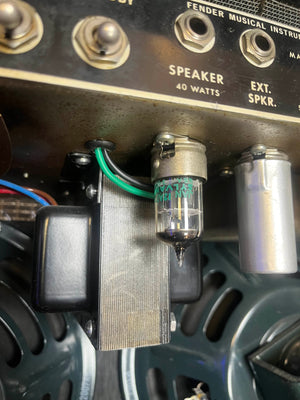 Close-up of an electronic vacuum tube and wiring inside a 1965 Fender Super Reverb - Black Panel - "Player’s Dream" Restoration by Guitars on Main, highlighting metal components and labeled speaker connections capturing the iconic Blackface sound.