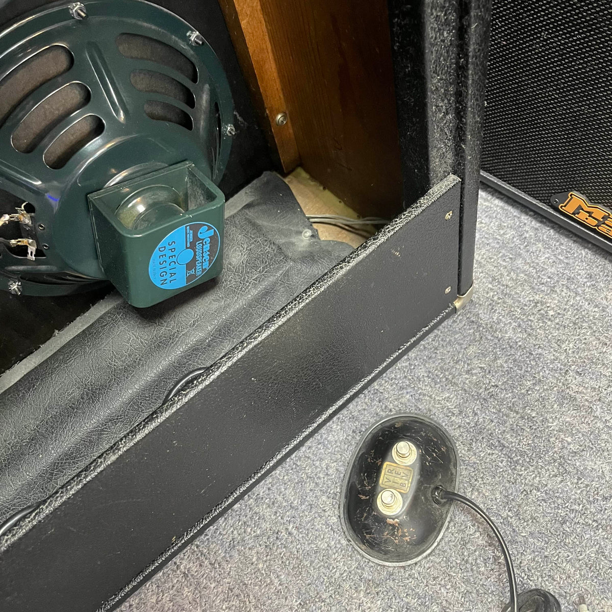 Close-up of a 1965 Fender Super Reverb - Black Panel from Guitars on Main, highlighting the "Special Design" speaker and footswitch on carpet—evoking classic tone. Available for local pickup.