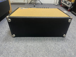 A 1966 Fender Black Panel Twin Reverb 2-Channel 85-Watt 2x12" Guitar Combo Amp w/Case sits on a grey carpeted floor, its blackface design and tan grille cloth evoking classic Fender spring reverb tones.