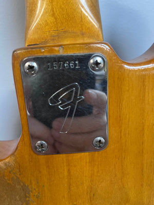 Close-up of a metal neck plate with serial number 157661 and "F" logo on a Fender 1966 Jazz Bass Natural Refinish w/Case, attached by four screws—a classic detail from this vintage bass guitar.