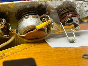 Close-up of a 1966 Fender Jazz Bass Natural Refinish w/Case by Fender, showing its vintage internal wiring with potentiometers, soldered wires, and metal parts mounted on wood—typical features of an original instrument.