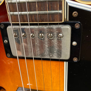 Close-up of 1967 Gibson ES-335 Sunburst guitar strings and screws.