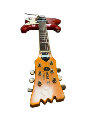 A red 1967 Mosrite Mark I Vintage Guitar with a maple headstock labeled "Vmosrite Custom" is shown from neck up against a white background, reflecting Mosrite’s iconic American guitar heritage.