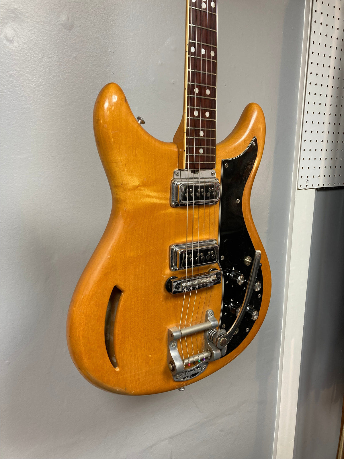 Close-up of the 1968 Kustom K-200A Vintage Guitar with original case, showcasing strings and pickups.