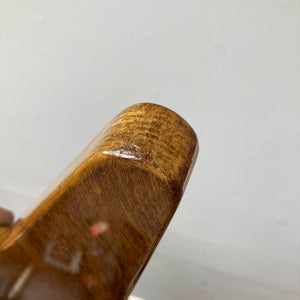 Close-up of the corner of a wooden object with a smooth, polished natural finish and visible wood grain, set against a plain light background—reminiscent of the craftsmanship seen on the 1975 Gibson Flying V w/Case by Gibson.