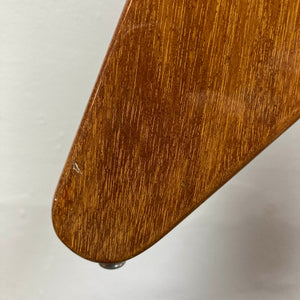 Close-up of a wooden furniture leg featuring a natural finish and glossy sheen, highlighting minor scratches and detailed wood grain reminiscent of the character found in a vintage 1975 Gibson Flying V w/Case by Gibson, set against a plain background.