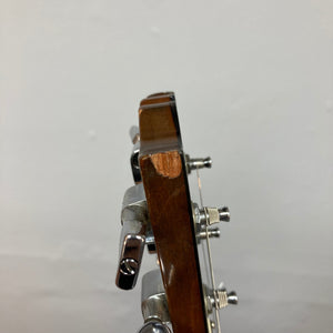 1975 Gibson SG Standard Walnut guitar, close-up of strings, body, and headstock, showcasing its high-quality craftsmanship and classic design.