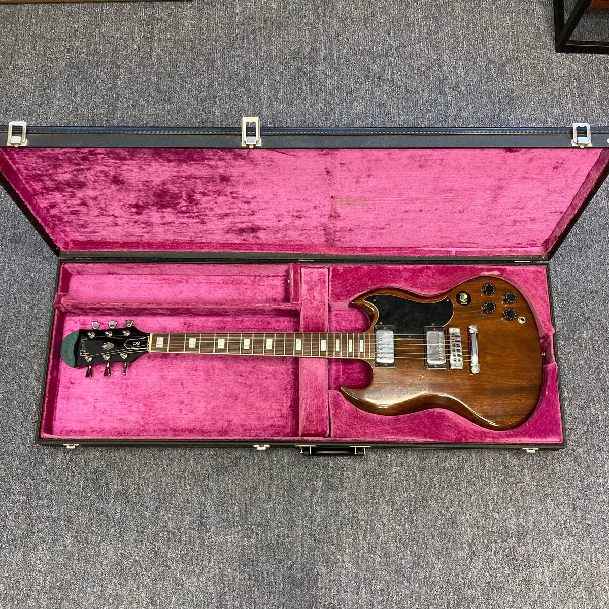 1975 Gibson SG Standard Walnut guitar in a pink velvet case.