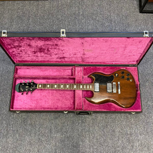 1975 Gibson SG Standard Walnut guitar in a pink velvet case.