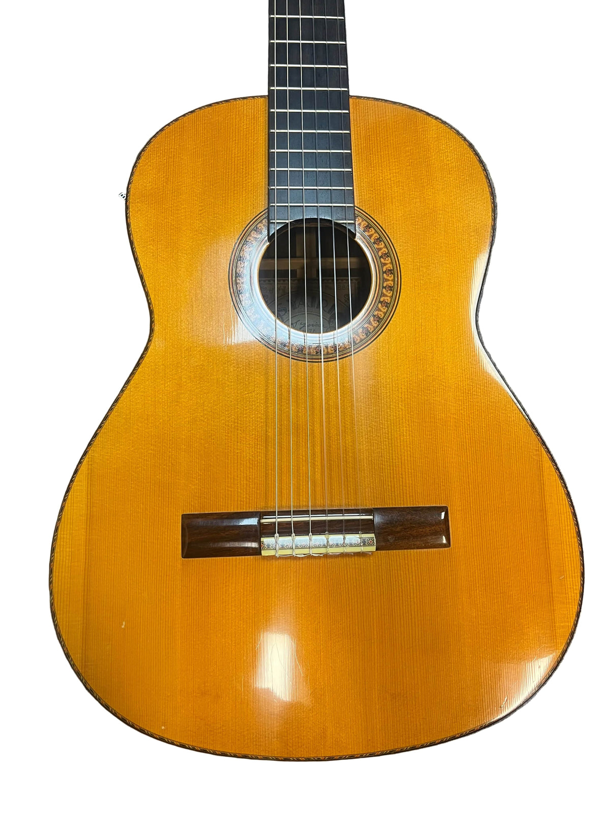 A 1976 S. Yairi No. 880 classical guitar by S Yairi, made in Japan, featuring a Brazilian rosewood body, visible strings, circular sound hole, and glossy finish—ideal for discerning musicians.