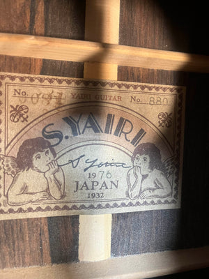 Close-up of the 1976 S. Yairi No. 880 Classical Guitar label (S Yairi brand), made in Japan, showing model info and cherub illustrations; this instrument may feature rare Brazilian rosewood.