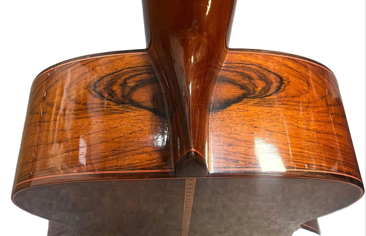 Close-up of the back and neck joint of a 1976 S. Yairi No. 880 Classical Guitar by S Yairi, made in Japan, highlighting the rich wood grain and glossy finish—possibly Brazilian rosewood.