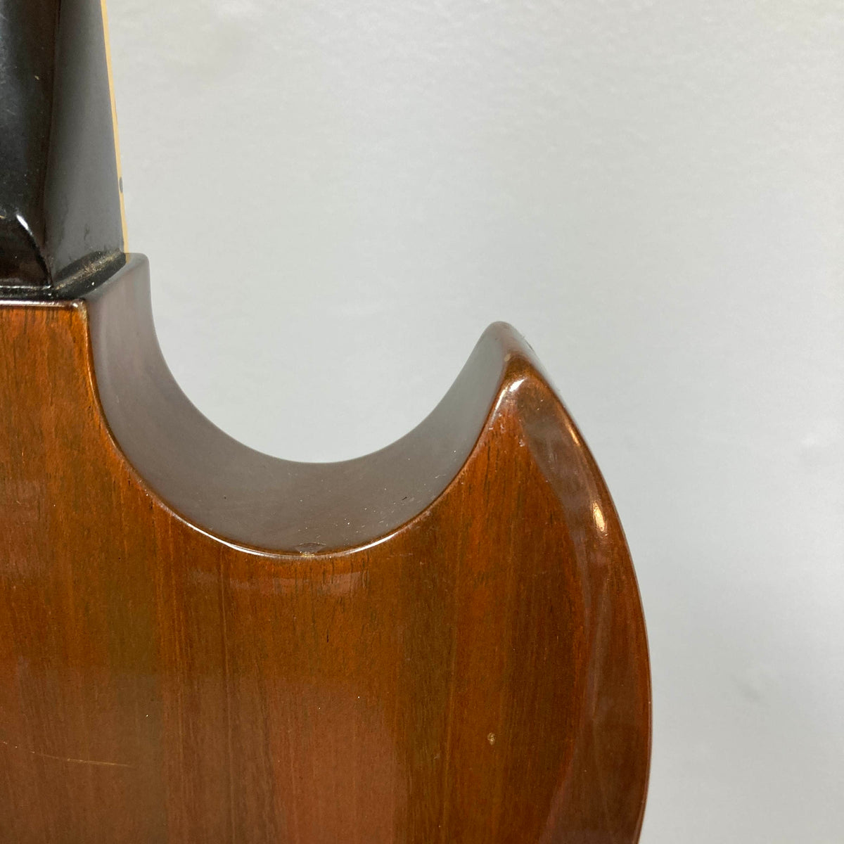 Close-up of the upper body and neck joint of a Gibson 1978 EDS-1275 Double Neck Walnut guitar with case, shown against a plain light-colored background.