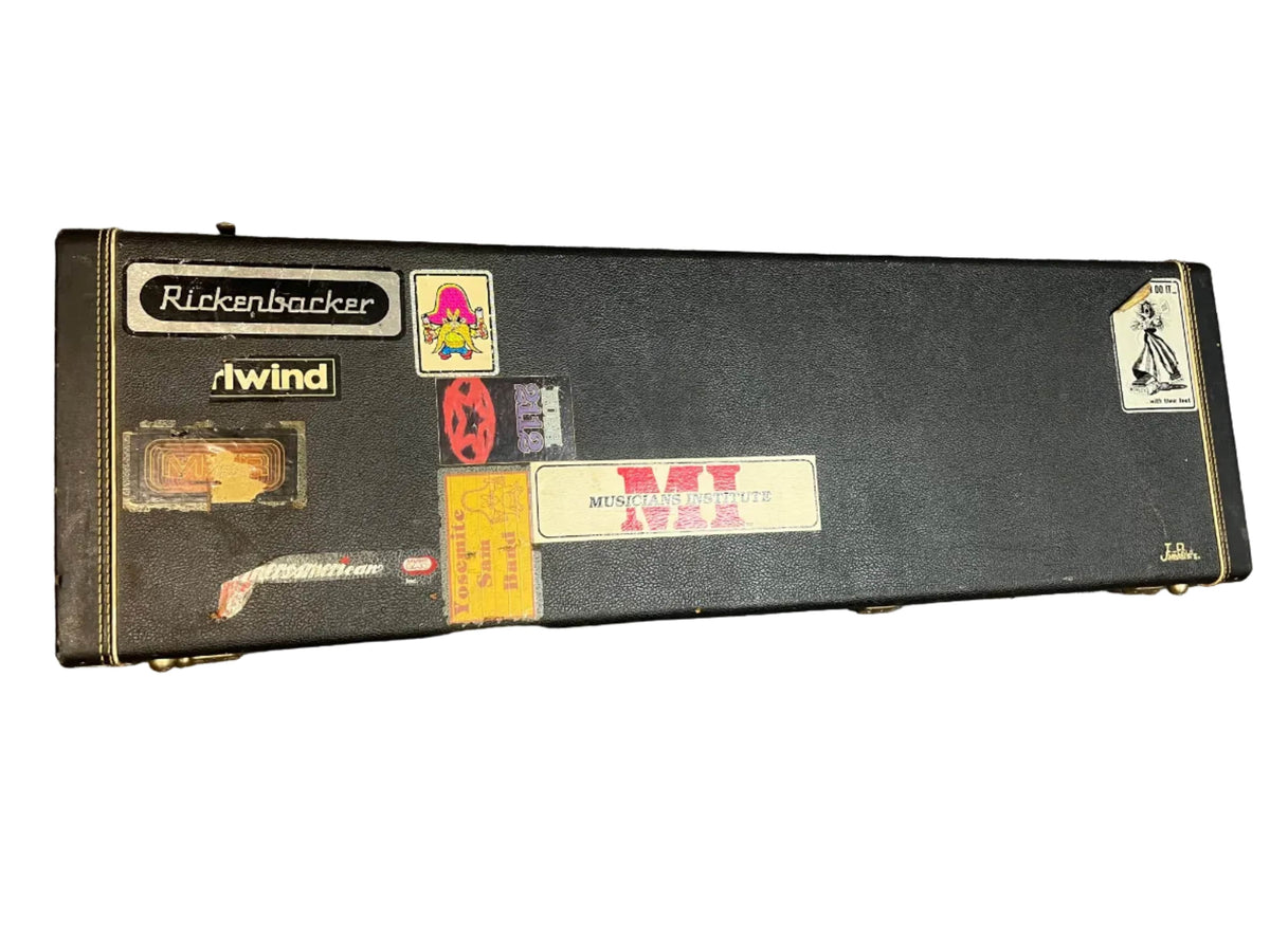 A black guitar case with stickers like "Rickenbacker" and "tw!nd," shown on a white background—ideal for carrying your 1978 Rickenbacker 4001 Bass — Fireglo (Serial RL7346) w/OHSC.