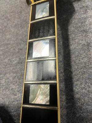 1980 Gibson Les Paul Custom fretboard close-up with block inlays, highlighting its authentic vintage wear and craftsmanship. Strings and frets removed.